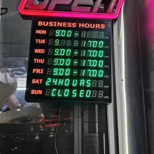 a neon sign for a business hours