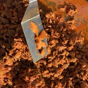 a spatula in a pot of ground beef