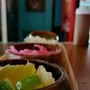 a row of wooden bowls filled with food