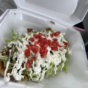 a taqueria with lettuce and tomatoes in a