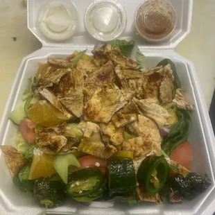 a salad in a styrofoam container