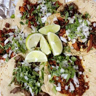 Top left and middle: Al pastor tacos; top right: campechino taco; bottom left: carne asada taco; bottom right: chorizo taco