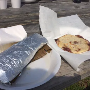 My chicken Tamale (huge size, in foil on left) and rice + beans pupusa (right)