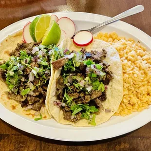 a plate of tacos and rice