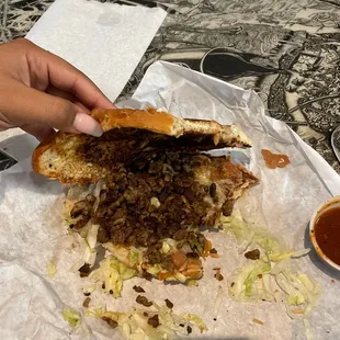 a person holding a sandwich