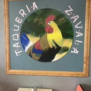 A sign inside the restaurant with the name of the restaurant.