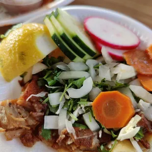 a taqueria zihuatanejo with vegetables and sliced radishes