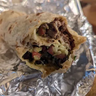 Super tinga de pollo burrito with black beans, hold the sour cream.  Filling.