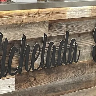 a wooden bar with metal letters