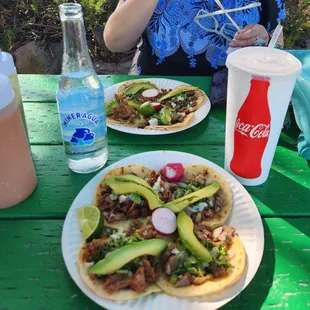 a plate of tacos and a bottle of coke