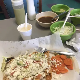 a taqueria sandwich with a side of vegetables