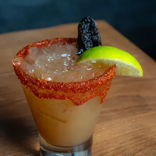 a closeup of a margarita with a lime slice
