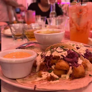 a plate of tacos and a drink