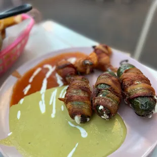 bacon wrapped jalapenos on a plate