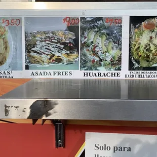 a taco stand with tacos on it