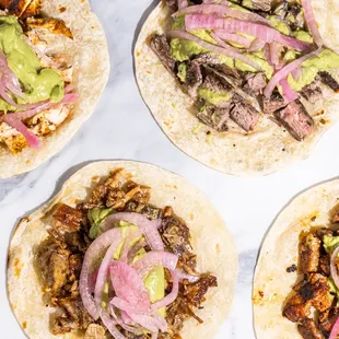 a variety of tacos on a table