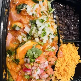 Shrimp Enchilado (Super Spicy Shrimp) with rice and beans.