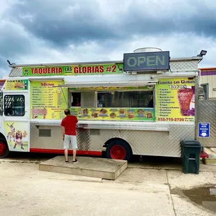  a man standing in front of a food truck