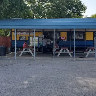 a taquito stand in a parking lot
