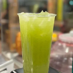 a green drink in a tall glass