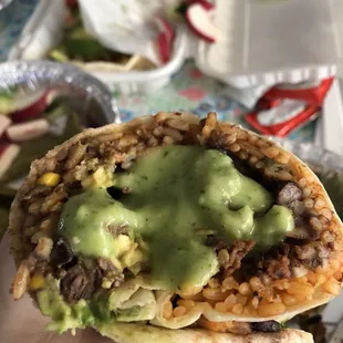 a hand holding a burrito