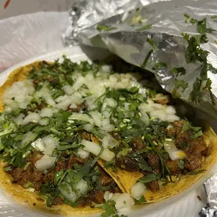 a taco with meat and onions