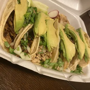 two tacos in a styrofoam container