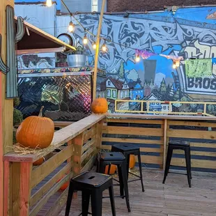 a woman sitting at a bar with pumpkins