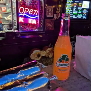 a hot dog and a bottle of soda