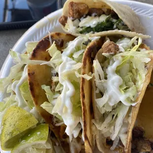 a plate of tacos and a cell phone