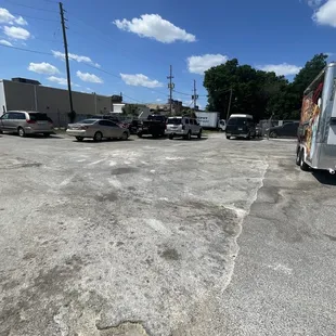The food trailer is located behind the fence
