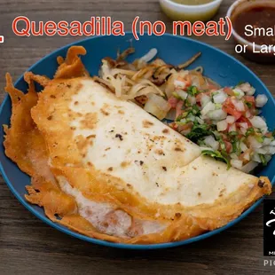 a plate of quesadilla with salsa