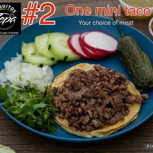 a plate of tacos with pickles and cucumbers