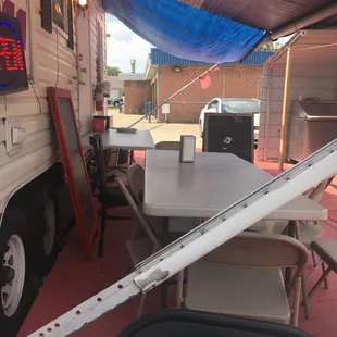a table and chairs under a tent