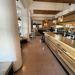 a view of a restaurant with a long counter