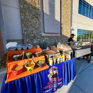 a buffet table outside of a building