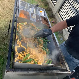 a man cooking food on a grill