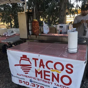 a man standing at a table with a glass of milk