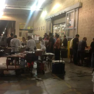 a group of people standing around a table