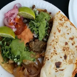 One pastor quesadilla, two tacos one chicken and one asada with all the trimmings