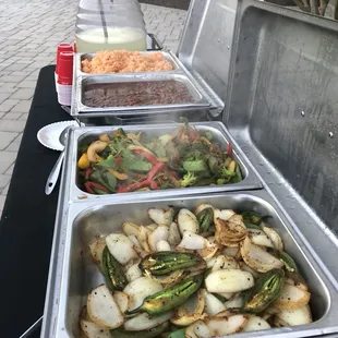 Some of our vegetarian opcions,veggie tray,Spanish rice,whole pinto beans,roasted onions and peppers