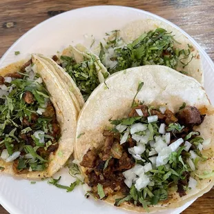 Pastor tacos on flour tortillas.