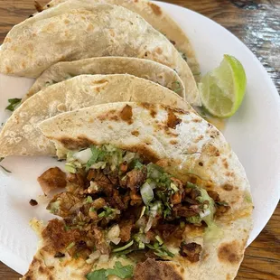 Pastor tacos on flour tortillas.