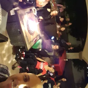 a group of people standing around a table