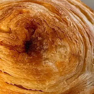 Handmade Pastél de Nata with a shatteringly crisp crust, featuring the characteristic swirl pattern