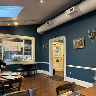 a restaurant with blue walls and wood floors