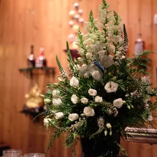 a vase of flowers on a bar