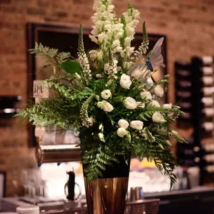 a vase of flowers on a bar