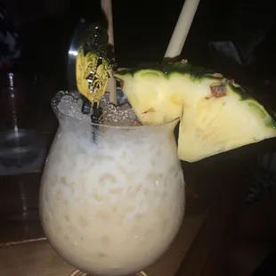 a drink with a pineapple garnish