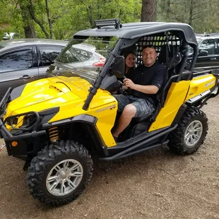 a man driving a yellow buggy